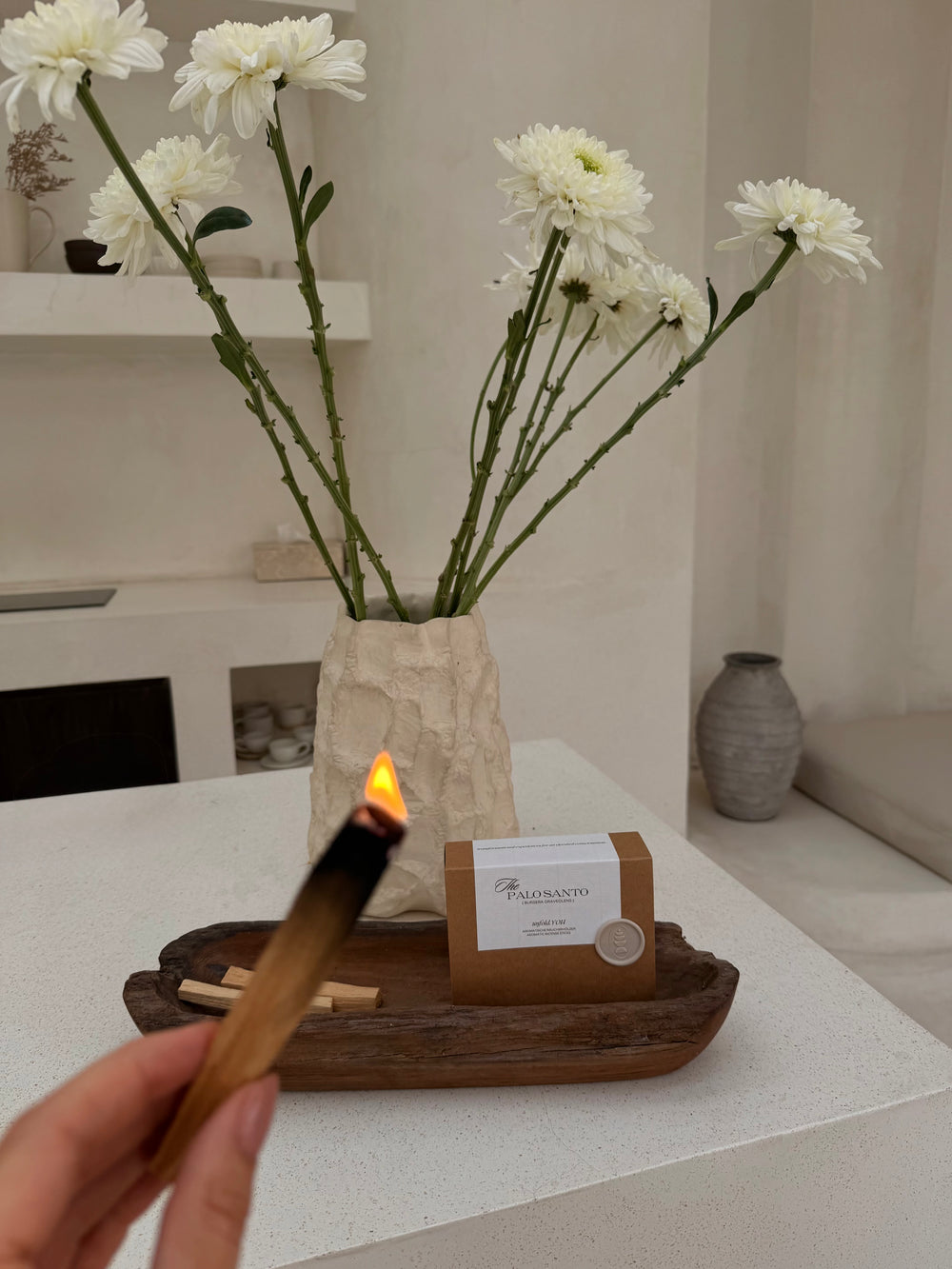 Close up of raw, hand-selected Palo Santo stick showing the natural wood grain and how it is lit.