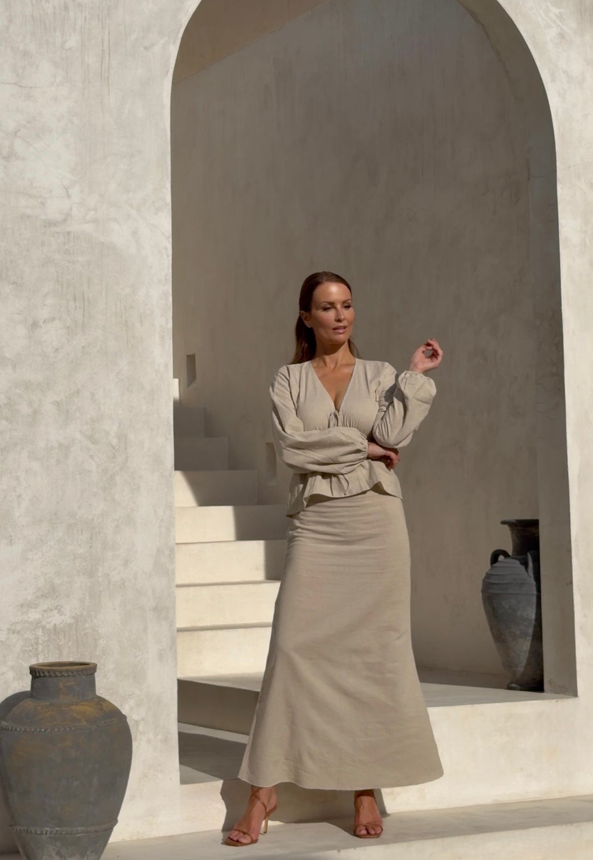 Full-length look of an undyed luxury long skirt with a fluid silhouette and a matching premium blouse, shot on location at a bright villa in Bali.