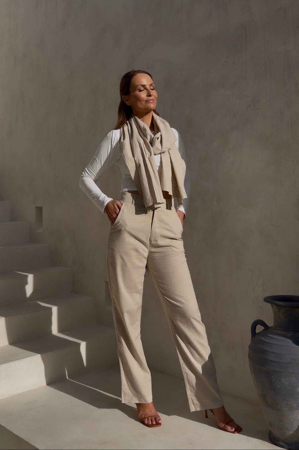 On-model full-length view of the undyed luxury trousers in a standing pose, showcasing their tailored high waist and elegant straight-leg silhouette.