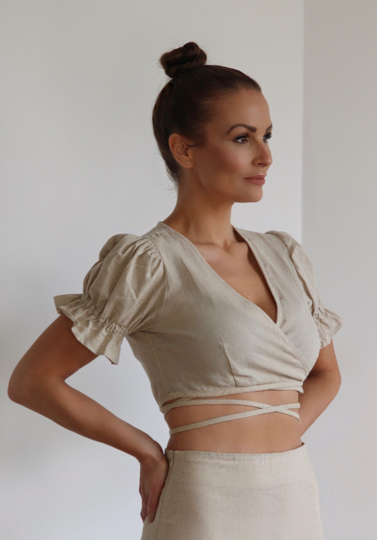 Close up of Alba wrap top witha v-neck and crossover strings bound in the back